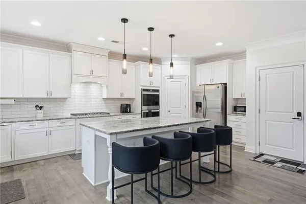 a view of kitchen with microwave and refrigerator