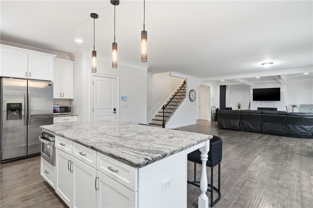 5115 Five Forks Trickum Road Southwest Lilburn, GA 30047 - Photo 21 of 63 a kitchen with granite countertop a stove and a sink