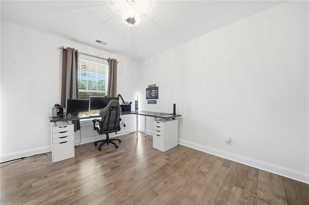 5115 Five Forks Trickum Road Southwest Lilburn, GA 30047 - Photo 25 of 63 a view of a workspace with furniture and a window