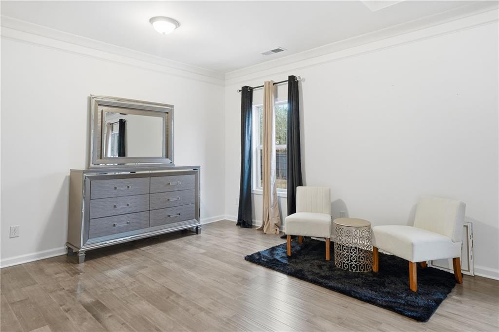 5115 Five Forks Trickum Road Southwest Lilburn, GA 30047 - Photo 30 of 63 a living room with furniture and wooden floor
