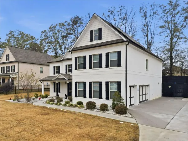 a front view of a house with garden and porch