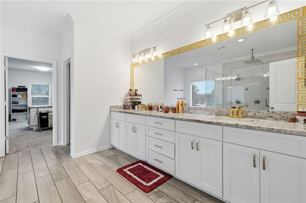 5115 Five Forks Trickum Road Southwest Lilburn, GA 30047 - Photo 31 of 63 a spacious bathroom with a granite countertop sink and a mirror