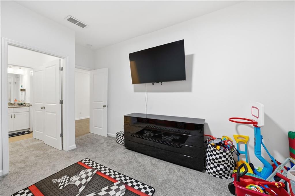 5115 Five Forks Trickum Road Southwest Lilburn, GA 30047 - Photo 39 of 63 a living room with furniture and a flat screen tv
