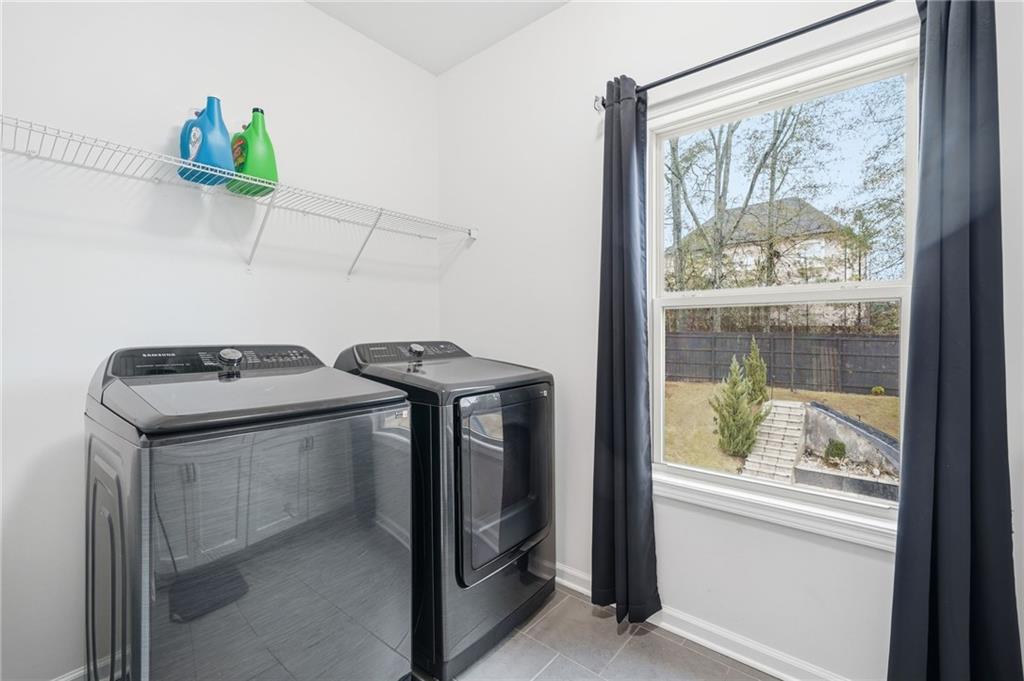 5115 Five Forks Trickum Road Southwest Lilburn, GA 30047 - Photo 46 of 63 a utility room with dryer and washer