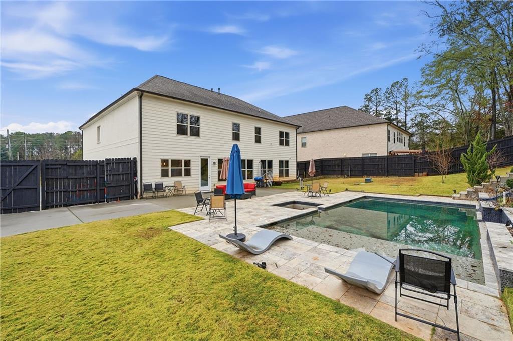 5115 Five Forks Trickum Road Southwest Lilburn, GA 30047 - Photo 49 of 63 a view of a house with swimming pool and sitting area