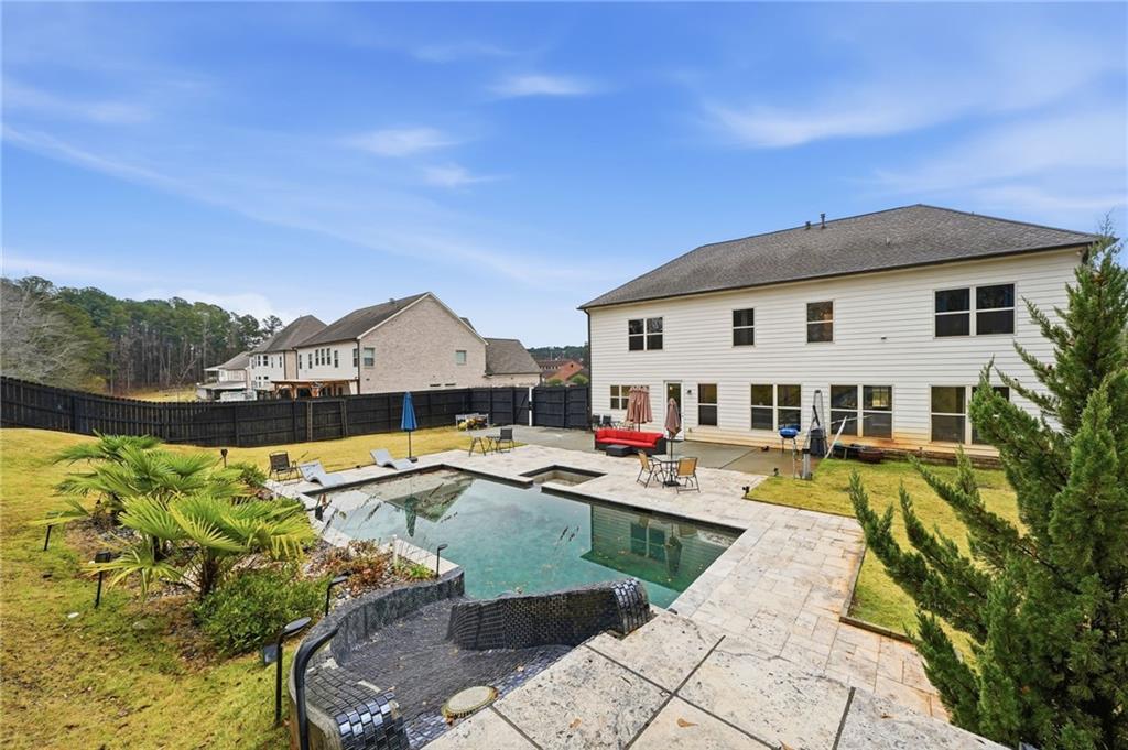 5115 Five Forks Trickum Road Southwest Lilburn, GA 30047 - Photo 50 of 63 a view of a house with swimming pool