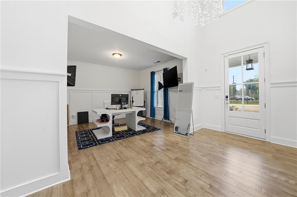 5115 Five Forks Trickum Road Southwest Lilburn, GA 30047 - Photo 7 of 63 a living room with furniture a flat screen tv and a refrigerator