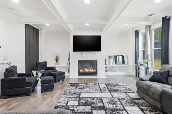 a living room with furniture and wooden floor