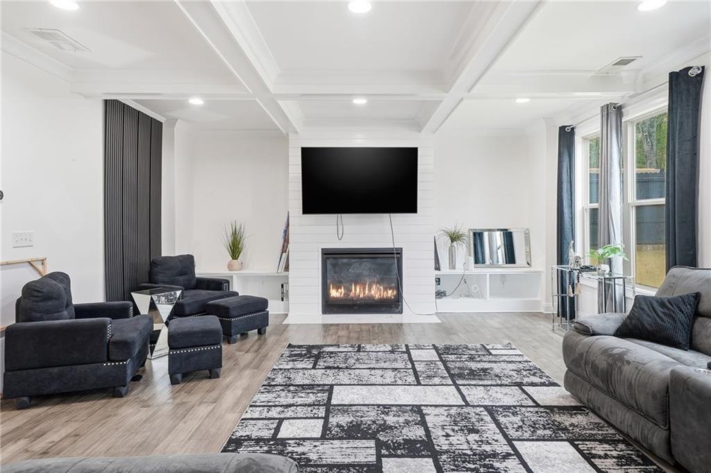 5115 Five Forks Trickum Road Southwest Lilburn, GA 30047 - Photo 10 of 63 a living room with furniture and a flat screen tv