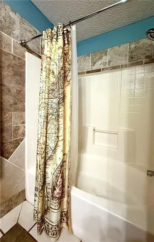 a bathroom with a shower and a tub