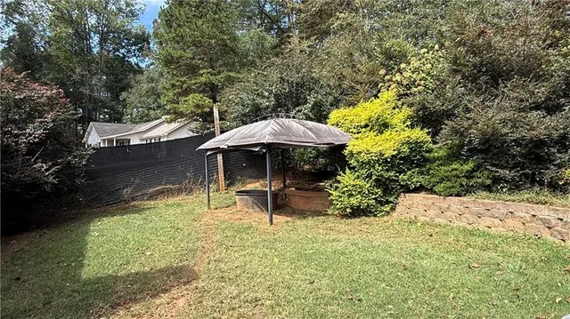 a backyard of a house with table and chairs