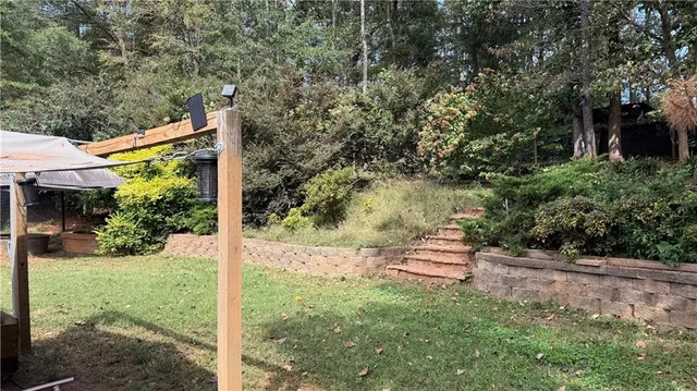 a backyard of a house with a yard and outdoor seating