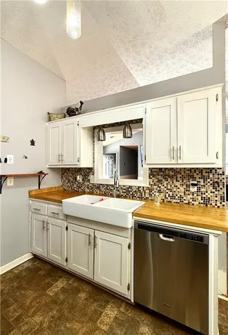a kitchen with stainless steel appliances and white cabinets