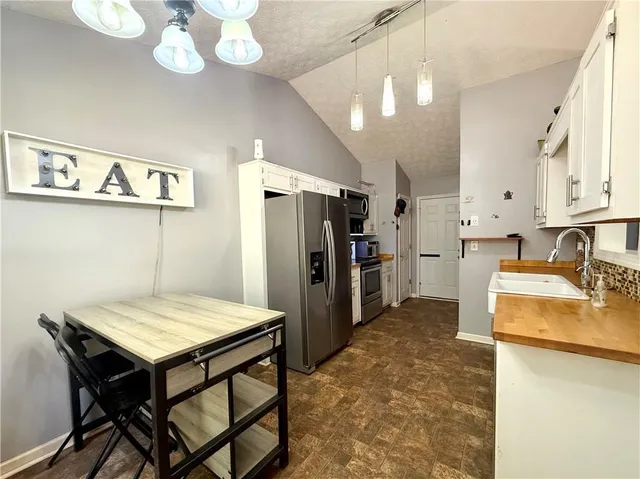 a kitchen with refrigerator and stove