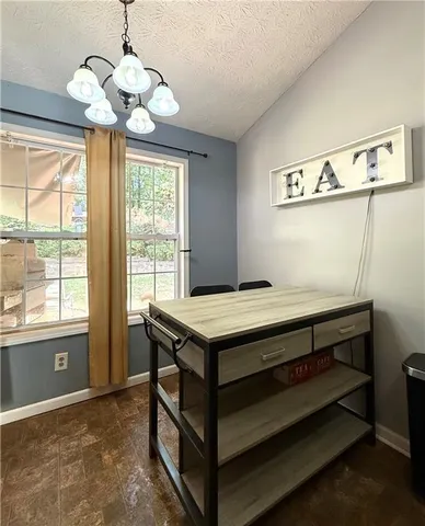 a kitchen that has a stove and a chandelier