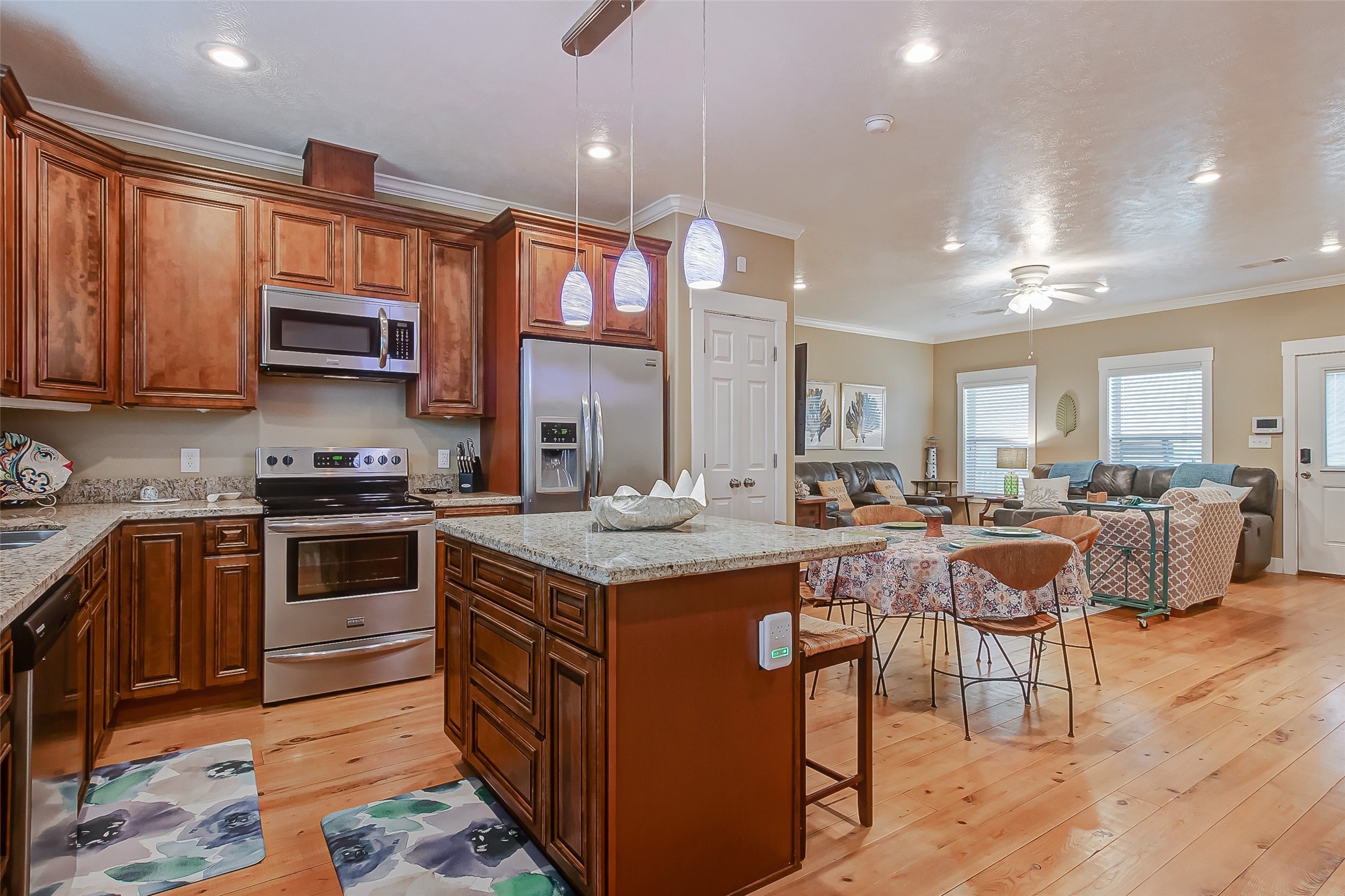 935 Westview Crystal Beach, TX 77650 - Photo 23 of 38 a kitchen with stainless steel appliances granite countertop a stove top oven a sink dishwasher and cabinets with wooden floor