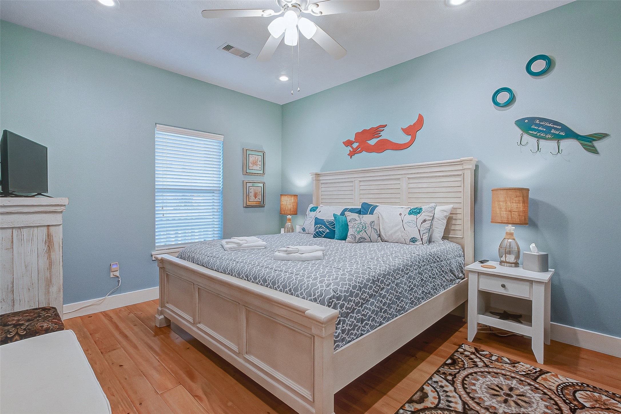 935 Westview Crystal Beach, TX 77650 - Photo 32 of 38 a bedroom with a bed and a chandelier