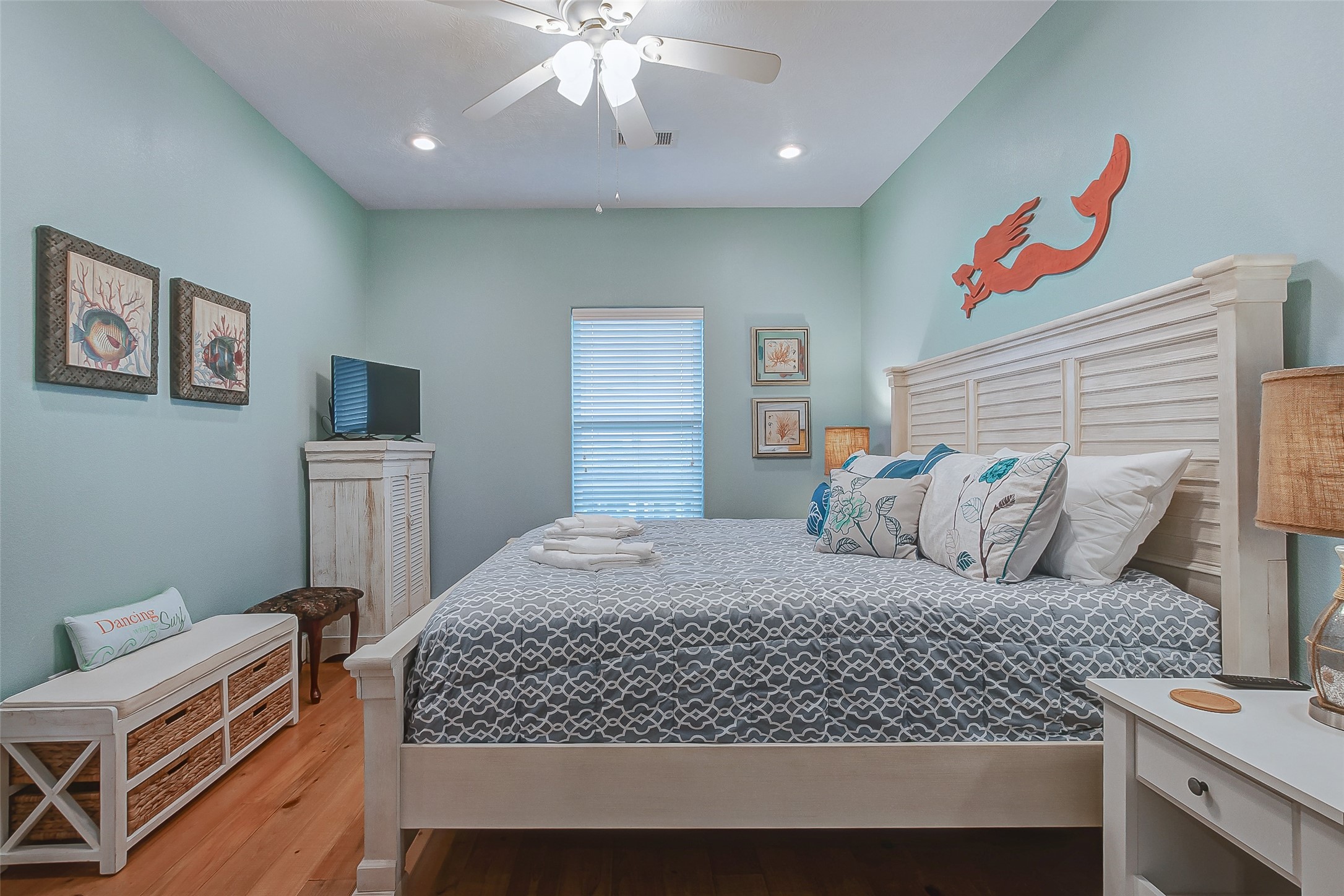 935 Westview Crystal Beach, TX 77650 - Photo 36 of 38 a bedroom with a large bed and a chandelier