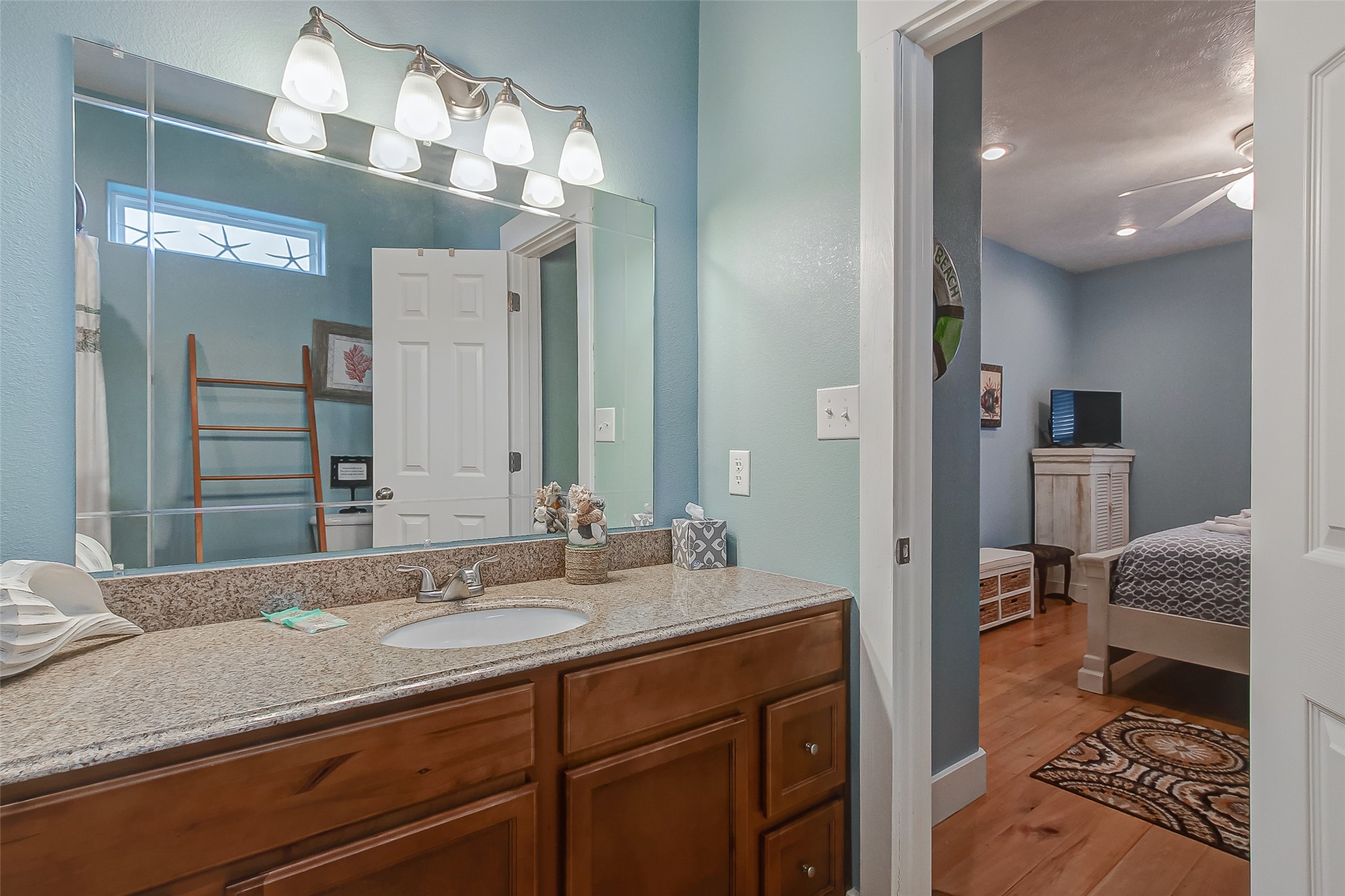 935 Westview Crystal Beach, TX 77650 - Photo 38 of 38 a en suite bathroom with a granite countertop sink and a mirror