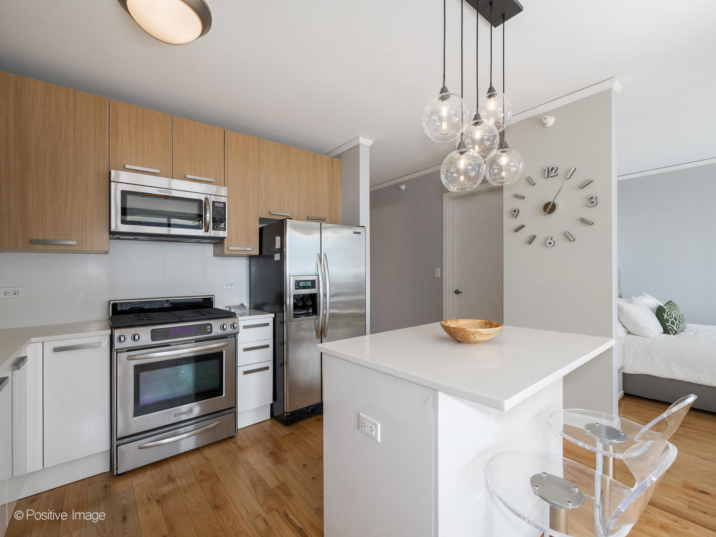 Undisclosed Address Chicago, IL 60601 - Photo 7 of 25 a kitchen with stainless steel appliances a stove a refrigerator sink and cabinets