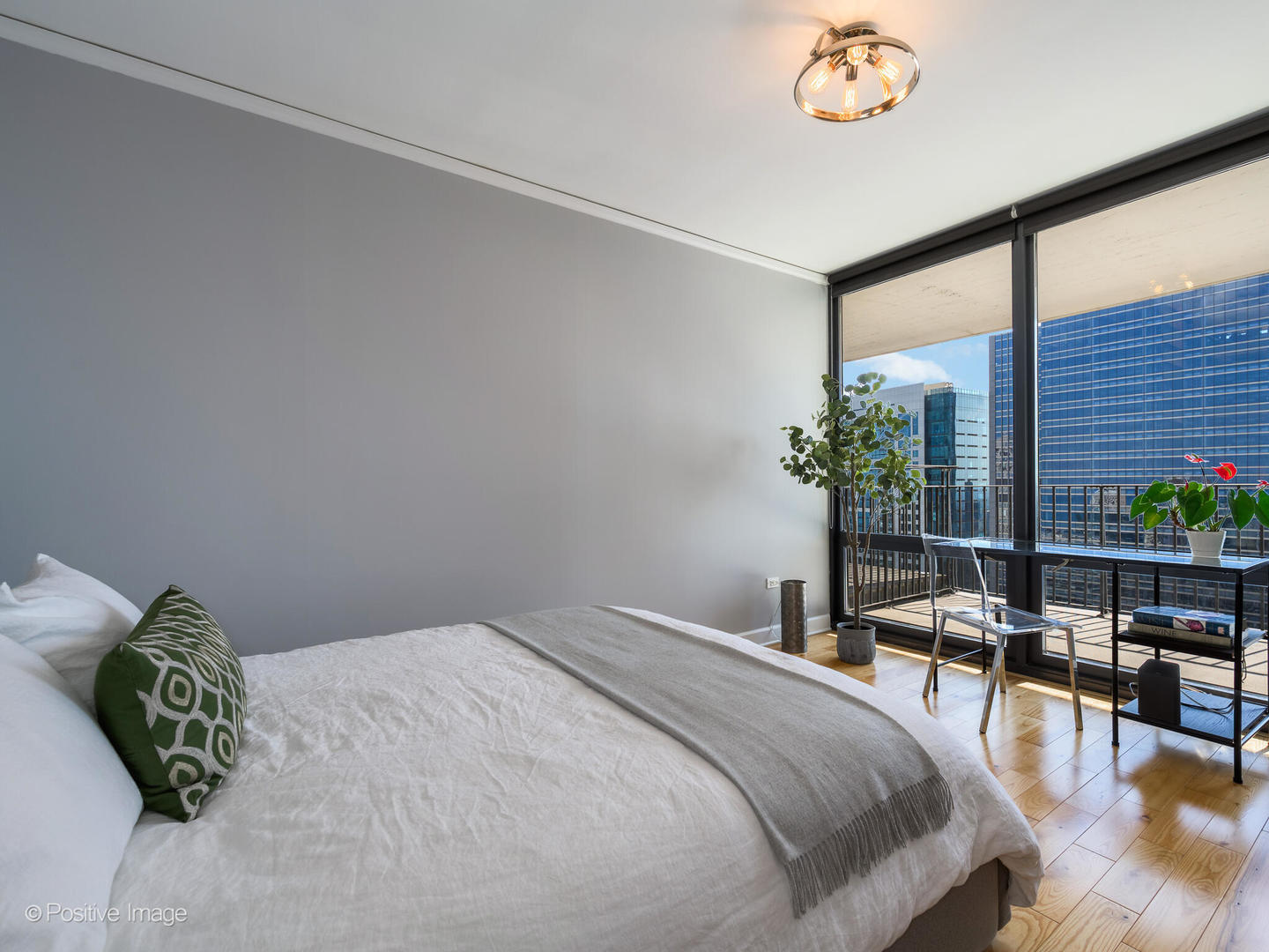 Undisclosed Address Chicago, IL 60601 - Photo 8 of 25 a bedroom with a bed table chair and a potted plant