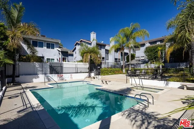 a view of a house with swimming pool and sitting area