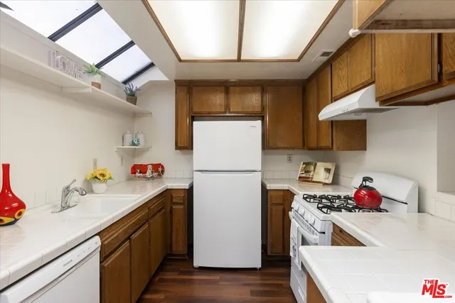 a kitchen with refrigerator and cabinets