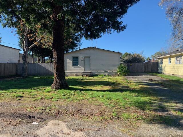 4040 Cedar Street Cutten, CA 95503 - Photo 19 of 21 a view of backyard with table and chairs and wooden fence