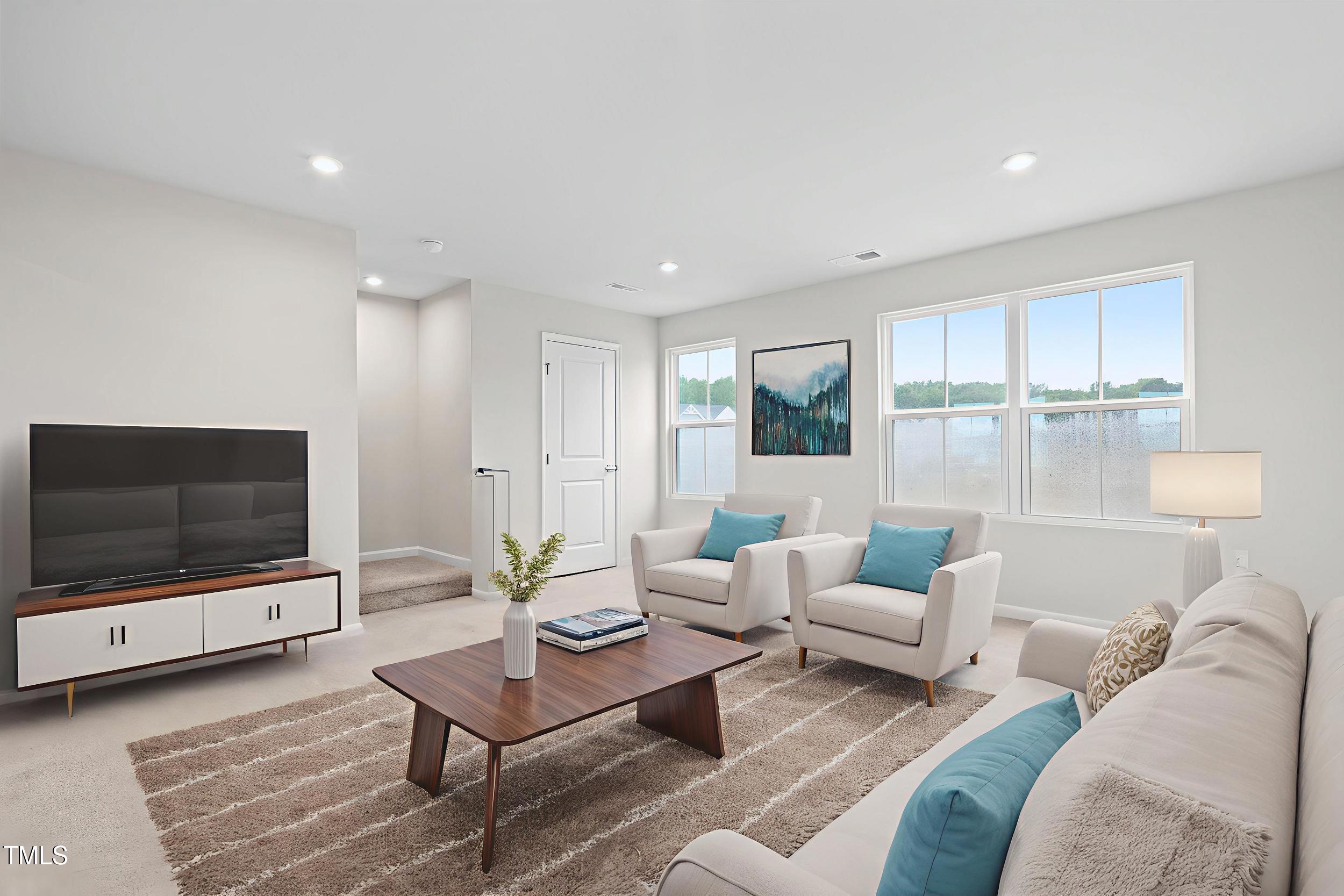 161 Sunny Acrs Road Raleigh, NC 27603 - Photo 13 of 27 a living room with furniture a flat screen tv and a floor to ceiling window