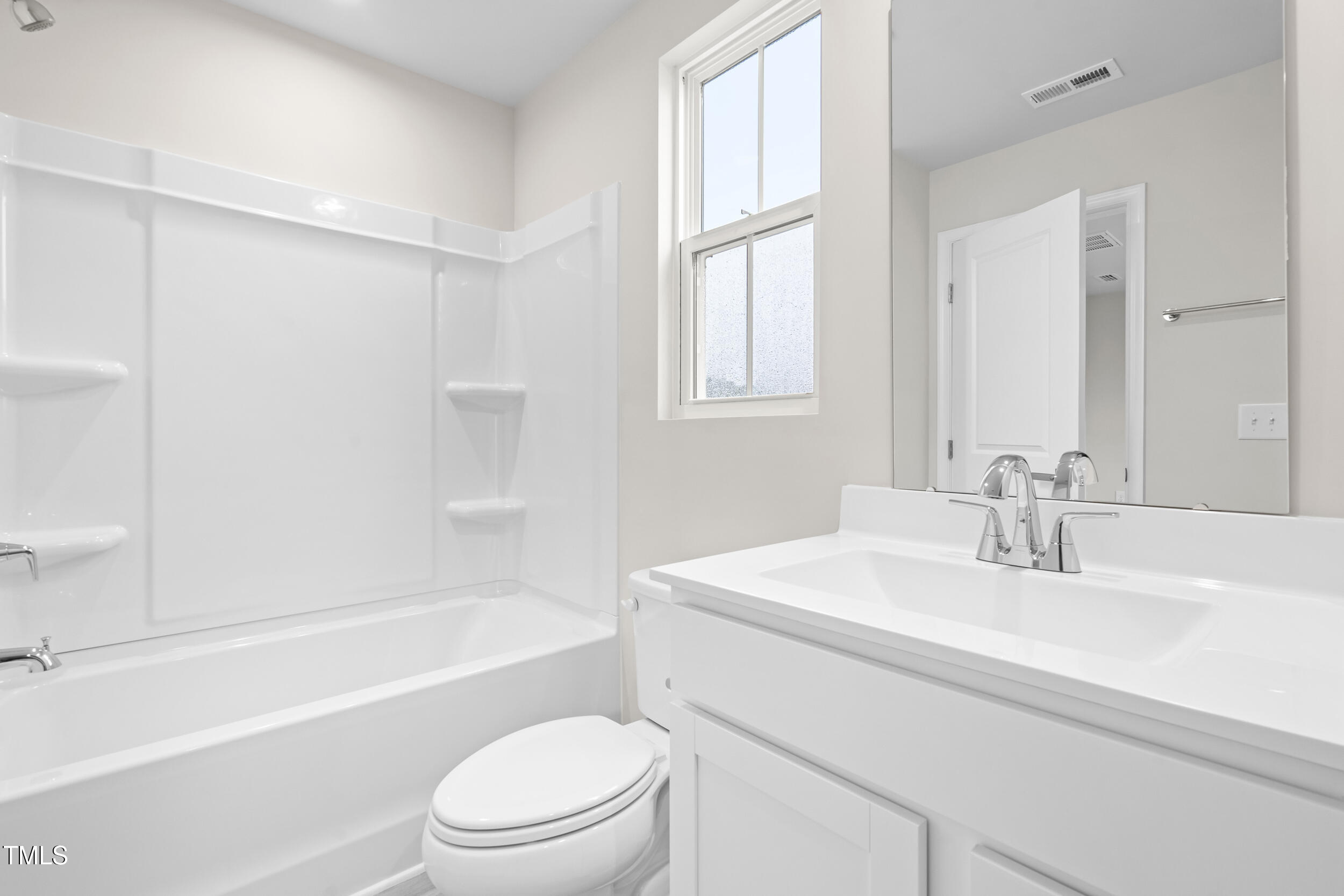 161 Sunny Acrs Road Raleigh, NC 27603 - Photo 18 of 27 a bathroom with a sink toilet vanity and tub