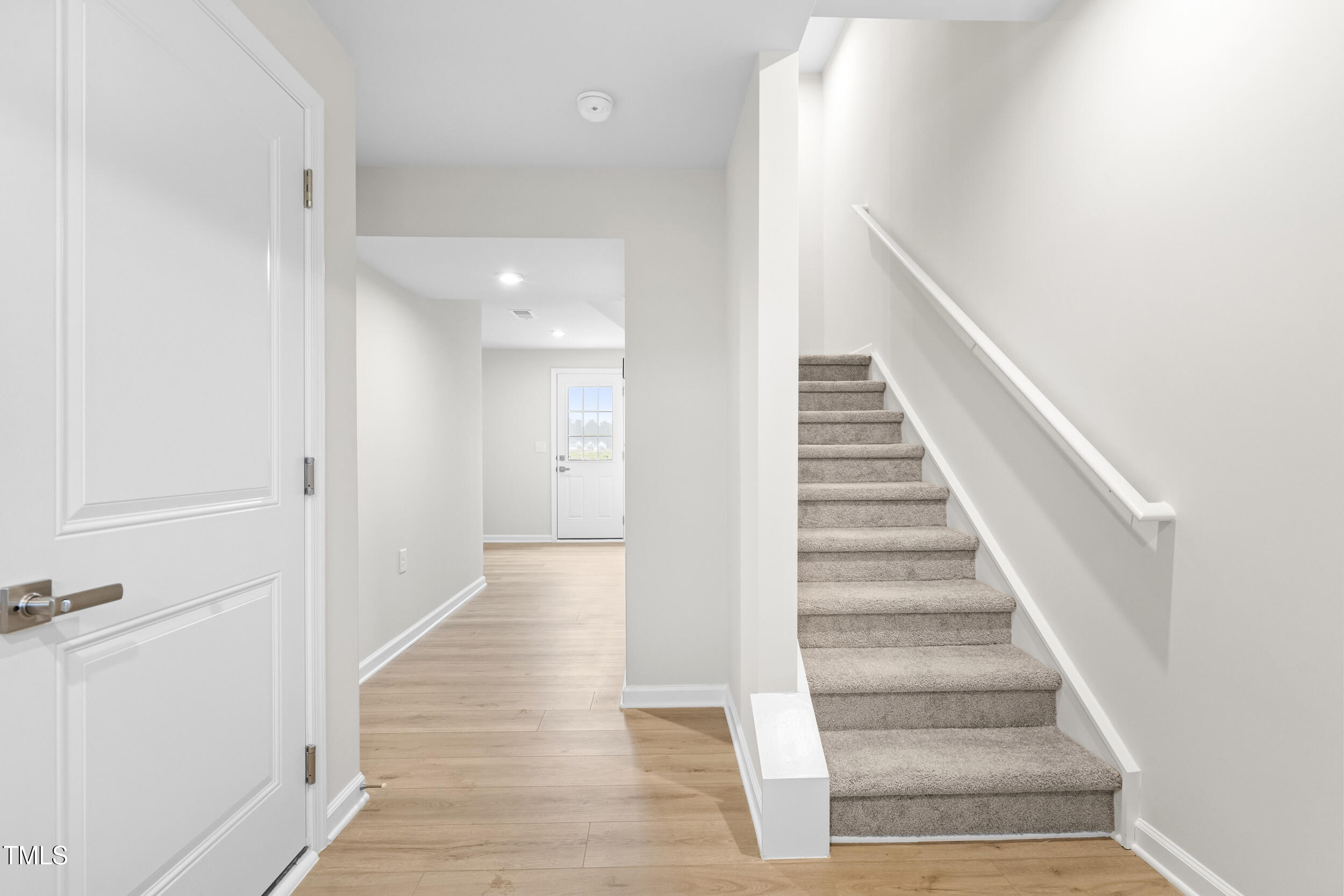161 Sunny Acrs Road Raleigh, NC 27603 - Photo 3 of 27 a view of a hallway with wooden floor and entryway