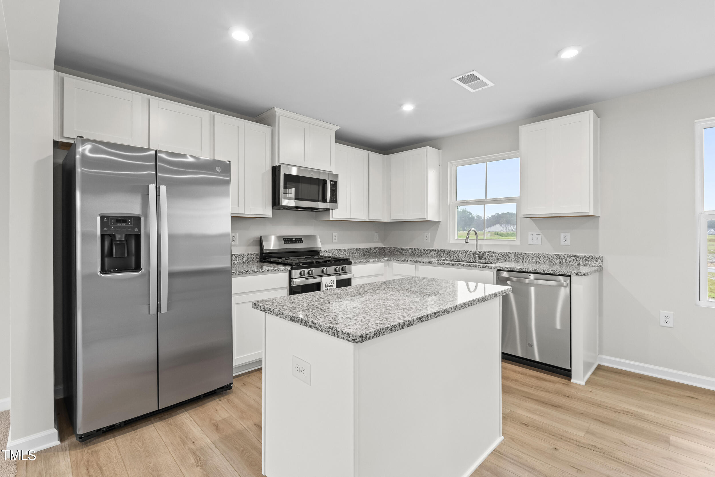 161 Sunny Acrs Road Raleigh, NC 27603 - Photo 4 of 27 a kitchen with a refrigerator sink and microwave