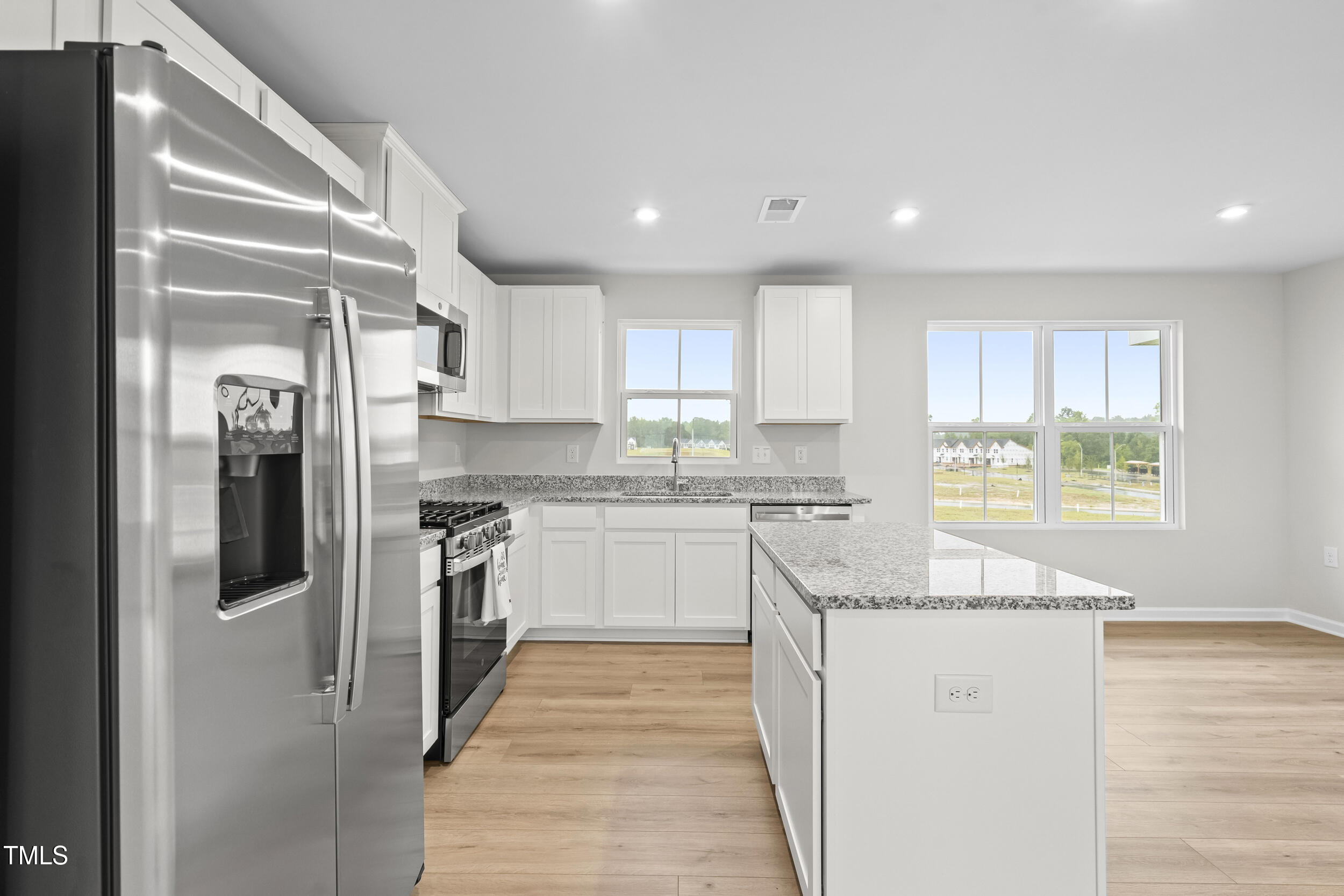 161 Sunny Acrs Road Raleigh, NC 27603 - Photo 5 of 27 a kitchen with stainless steel appliances granite countertop a refrigerator a sink and a stove