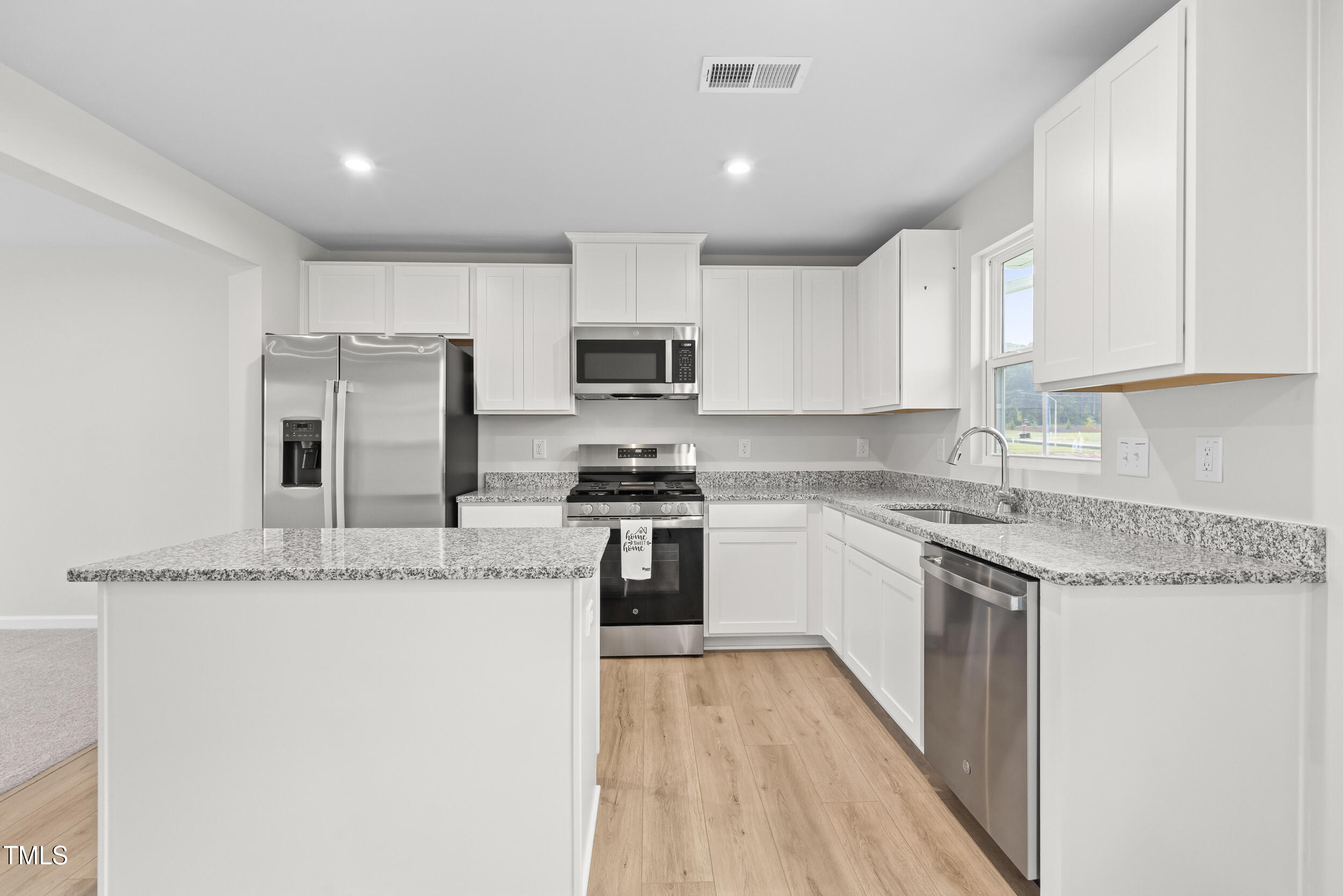 161 Sunny Acrs Road Raleigh, NC 27603 - Photo 6 of 27 a kitchen with granite countertop a stove top oven a sink dishwasher and a refrigerator with wooden floor
