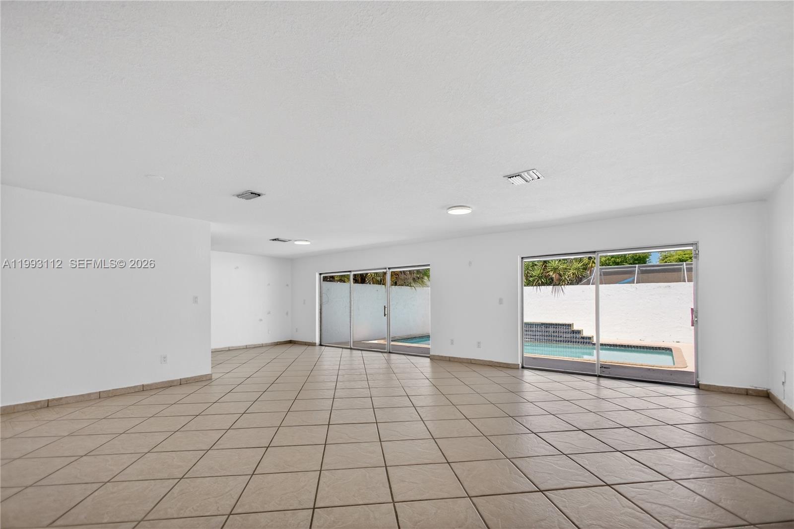 13471 Southwest 99th Terrace Miami, FL 33186 - Photo 17 of 44 a view of an empty room and window