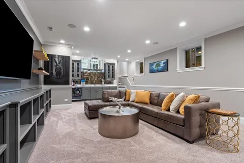 a living room with furniture and a book shelf