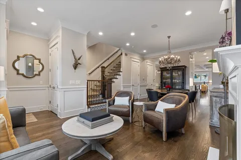 a living room with furniture and a chandelier