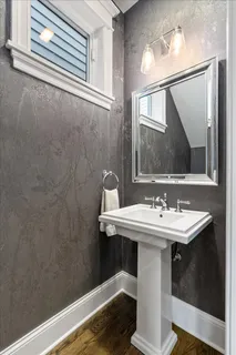 a bathroom with a sink a mirror and vanity