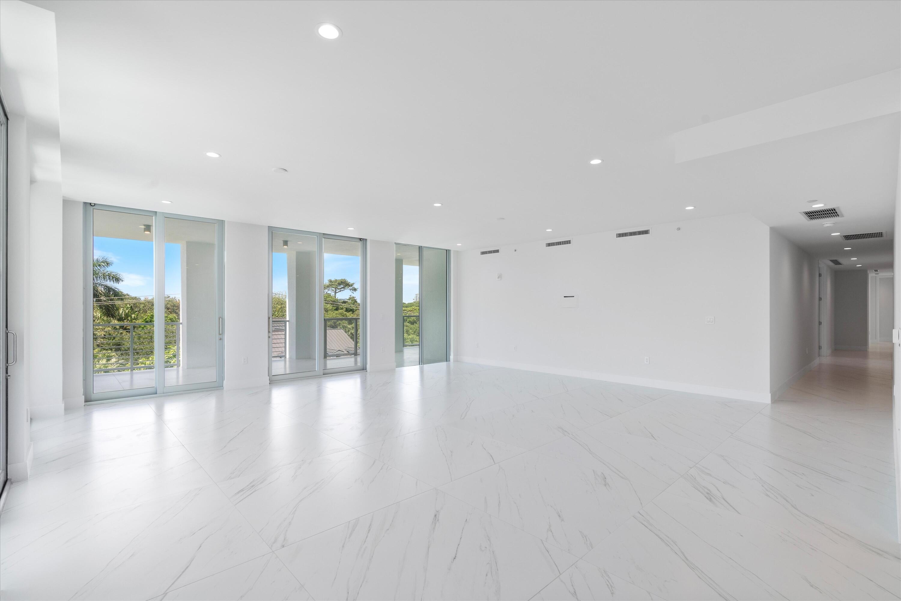 495 East Royal Palm Road, Unit 402 Boca Raton, FL 33432 - Photo 5 of 72 a view of an empty room with glass door and windows