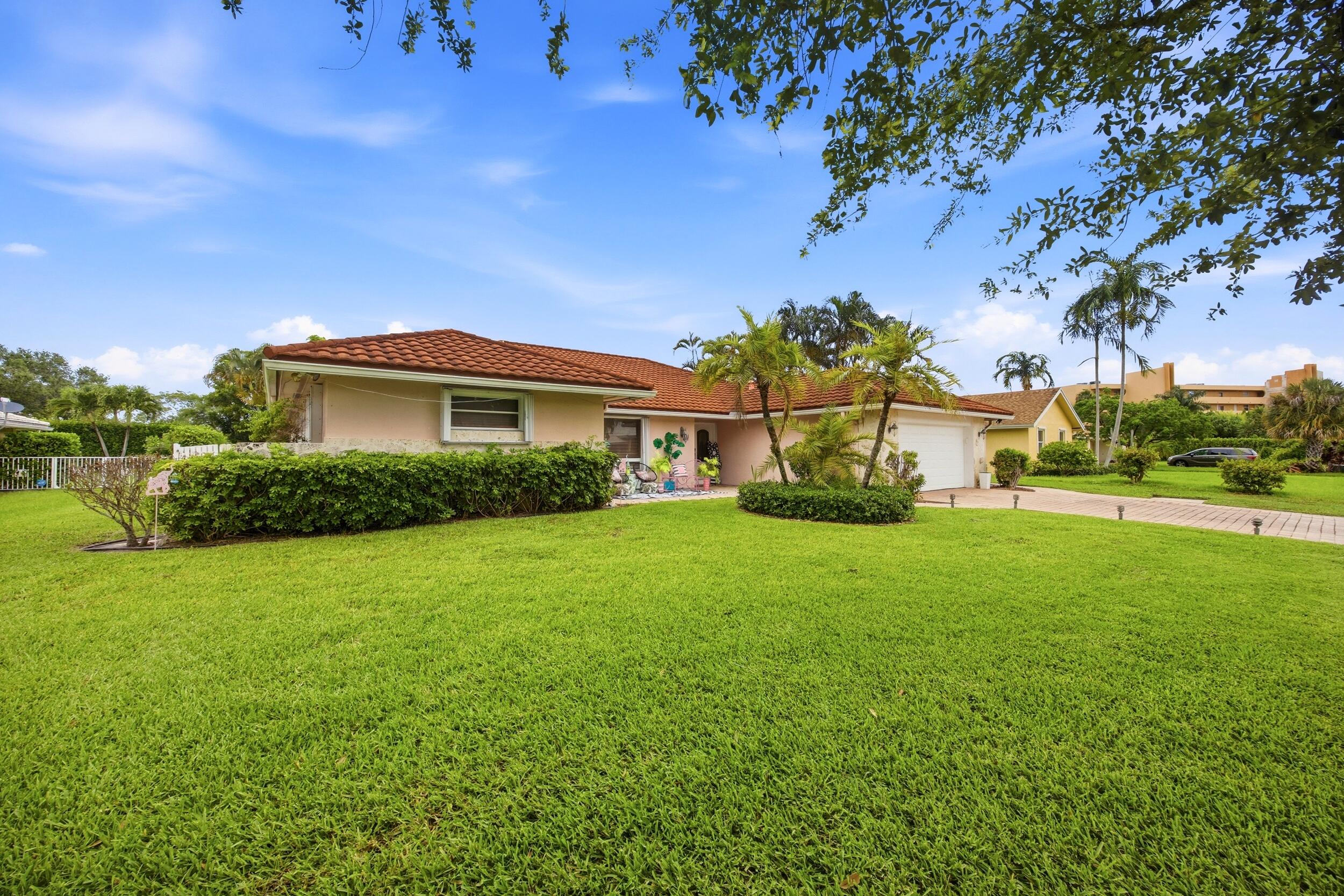 375 Northwest 53rd Street Boca Raton, FL 33487 - Photo 2 of 14 a view of a house with a backyard