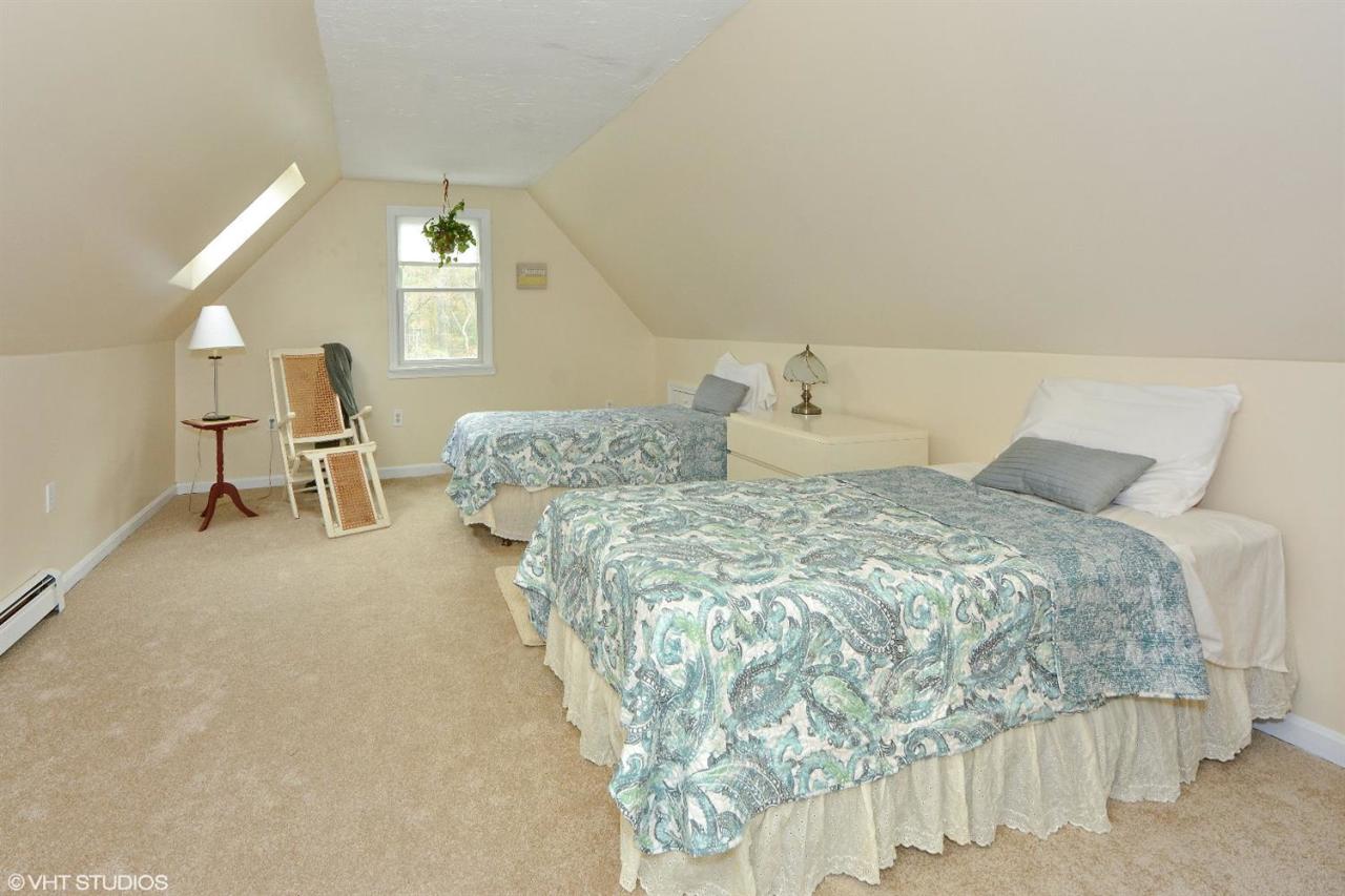 91 Clay Pond Road Bourne, MA 02532 - Photo 12 of 15 a bedroom with a bed and mirror