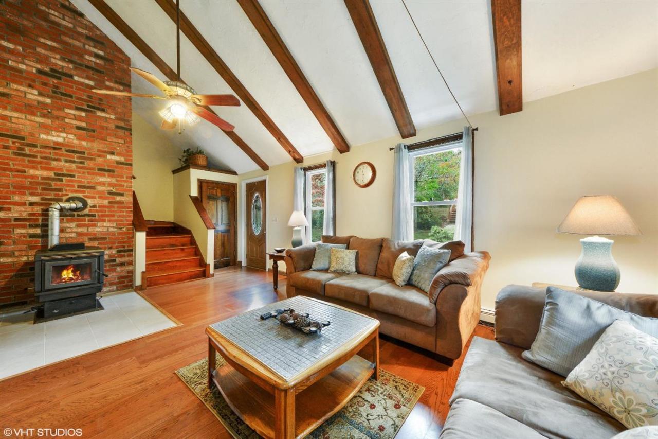 91 Clay Pond Road Bourne, MA 02532 - Photo 3 of 15 a living room with furniture and a fireplace