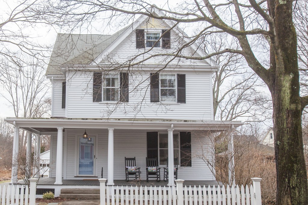 a view of a white house with large windows