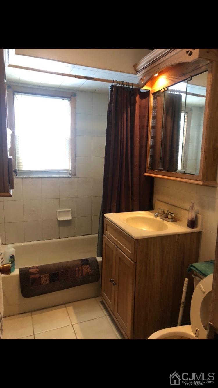 22 Stevens Road Edison, NJ 08817 - Photo 5 of 8 a bathroom with a bathtub and shower