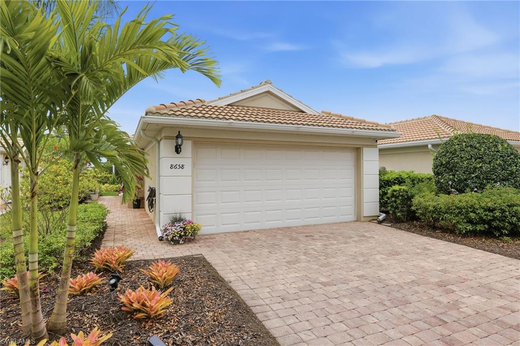 8658 Genova Court Naples, FL 34114 - Photo 2 of 49 Attached 2-car Garage with pavers and side entrance