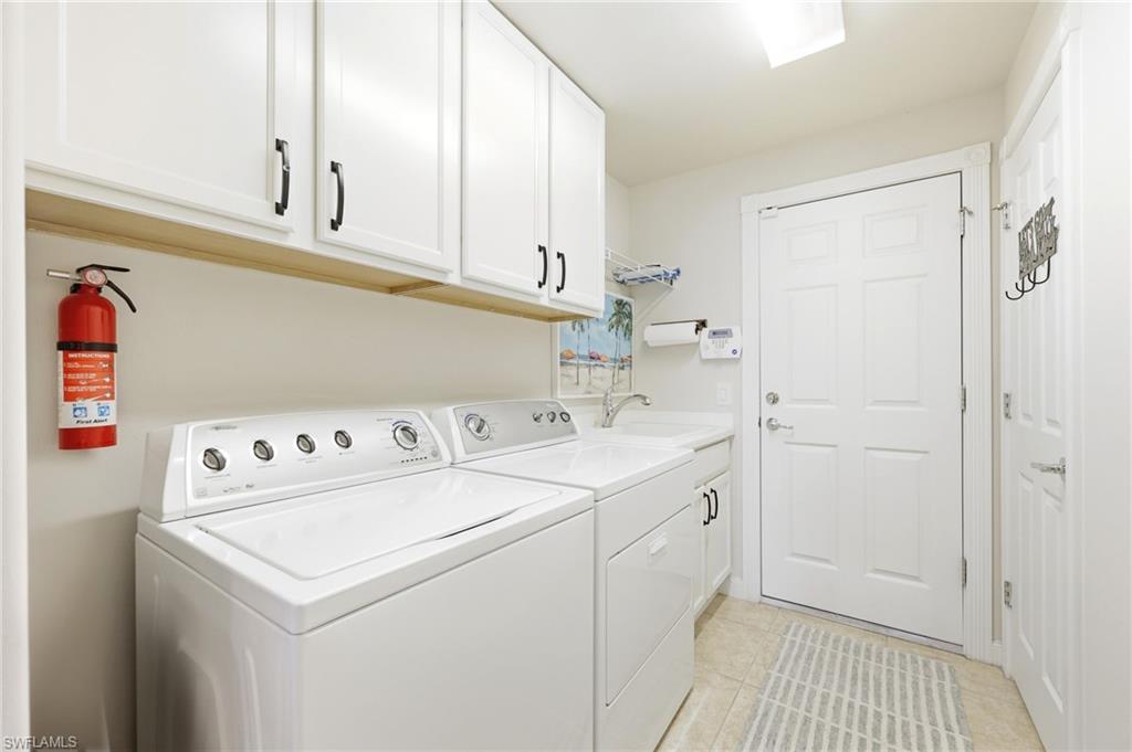 8658 Genova Court Naples, FL 34114 - Photo 27 of 49 Laundry Room with Sink, Washer & Dryer and access to the Garage