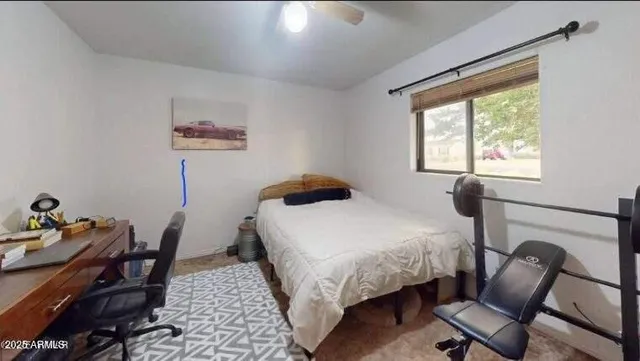 a view of a livingroom with furniture hardwood floor and a ceiling fan