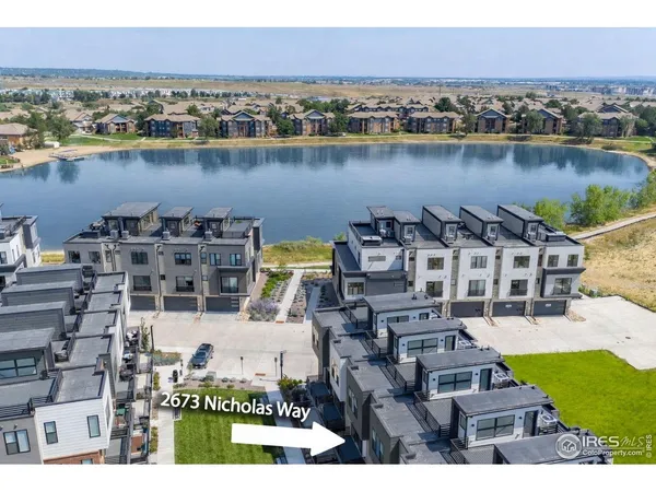 an aerial view of a house with a lake view