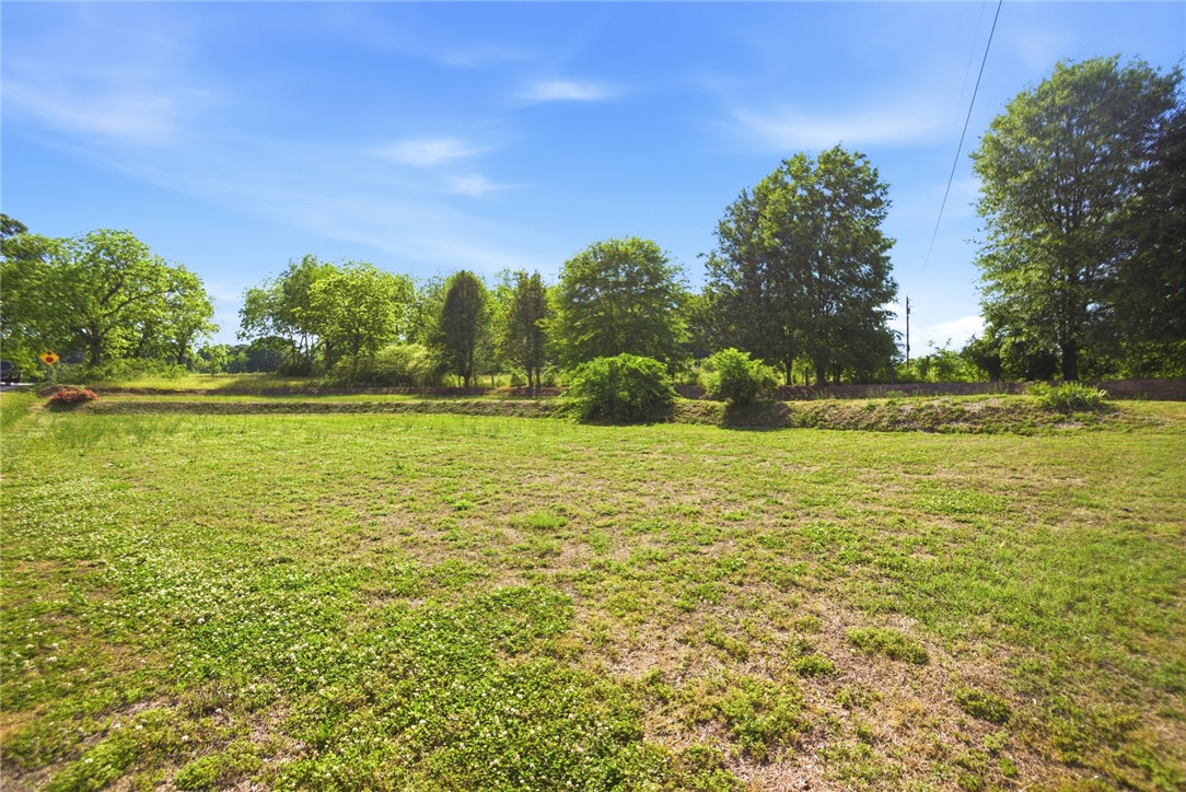 282 West Bennett Road Westminster, SC 29693 - Photo 36 of 42 Expansive green spaces offer endless possibilities for outdoor enjoyment under a clear sky.