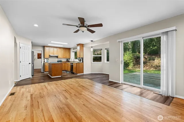 a living room with furniture a flat screen tv and a window